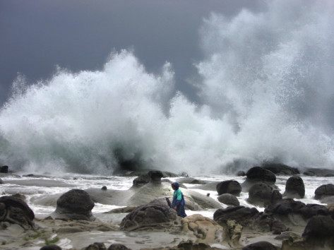 a-taiwanese-man-is-dwarfed-by-huge-waves-driven-by-approaching-typhoon-talim.jpg